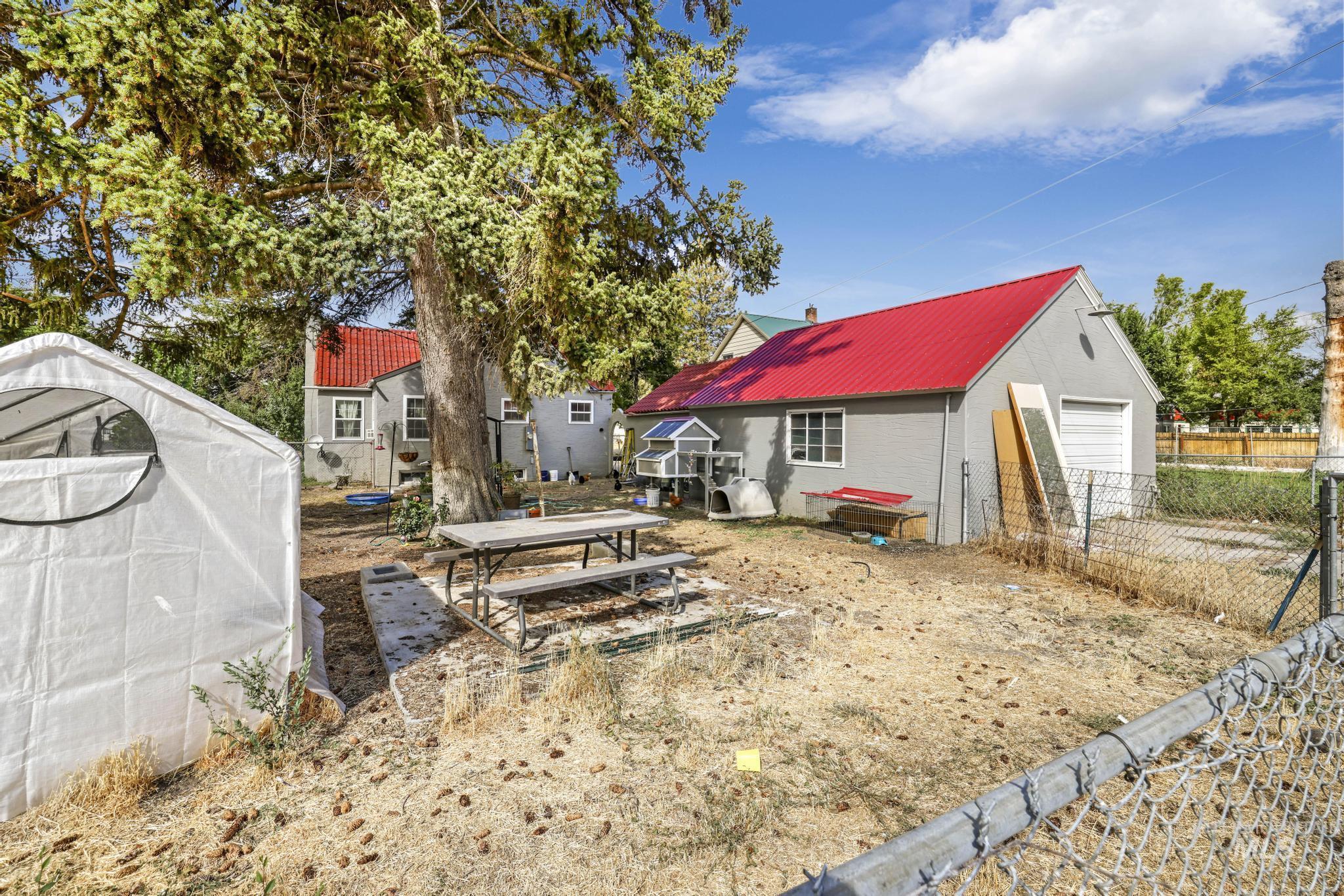 602 4th Avenue East Gooding, ID 83330 - Photo 27 of 36 View of yard with an outdoor structure, a patio, and a greenhouse