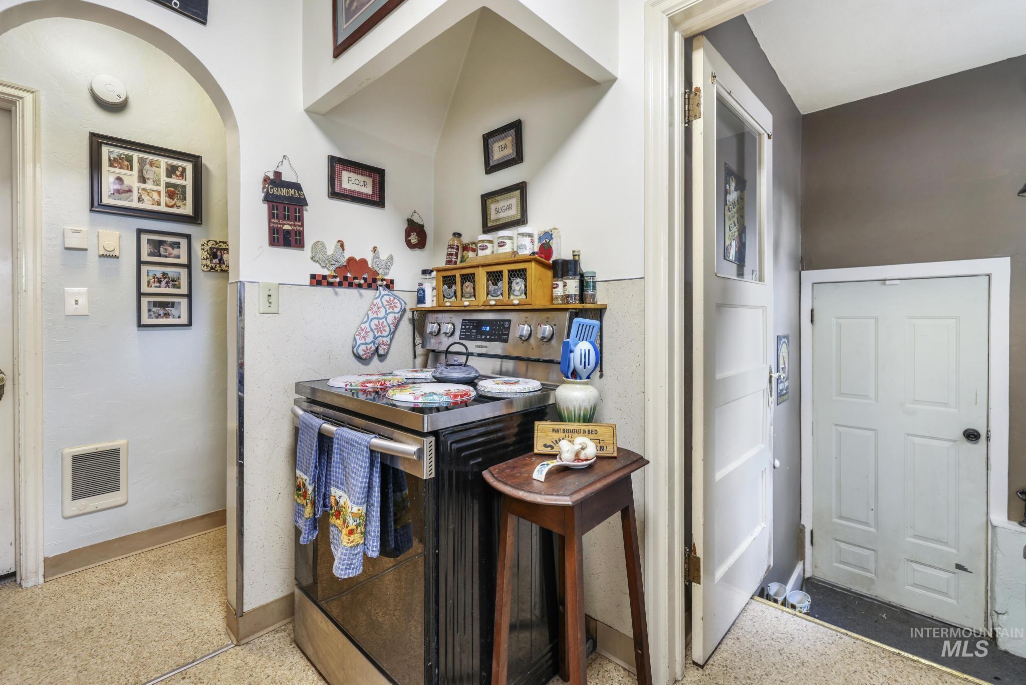 602 4th Avenue East Gooding, ID 83330 - Photo 5 of 36 Kitchen with stainless steel range with electric stovetop, heating unit, dark speckled floor, and arched walkways