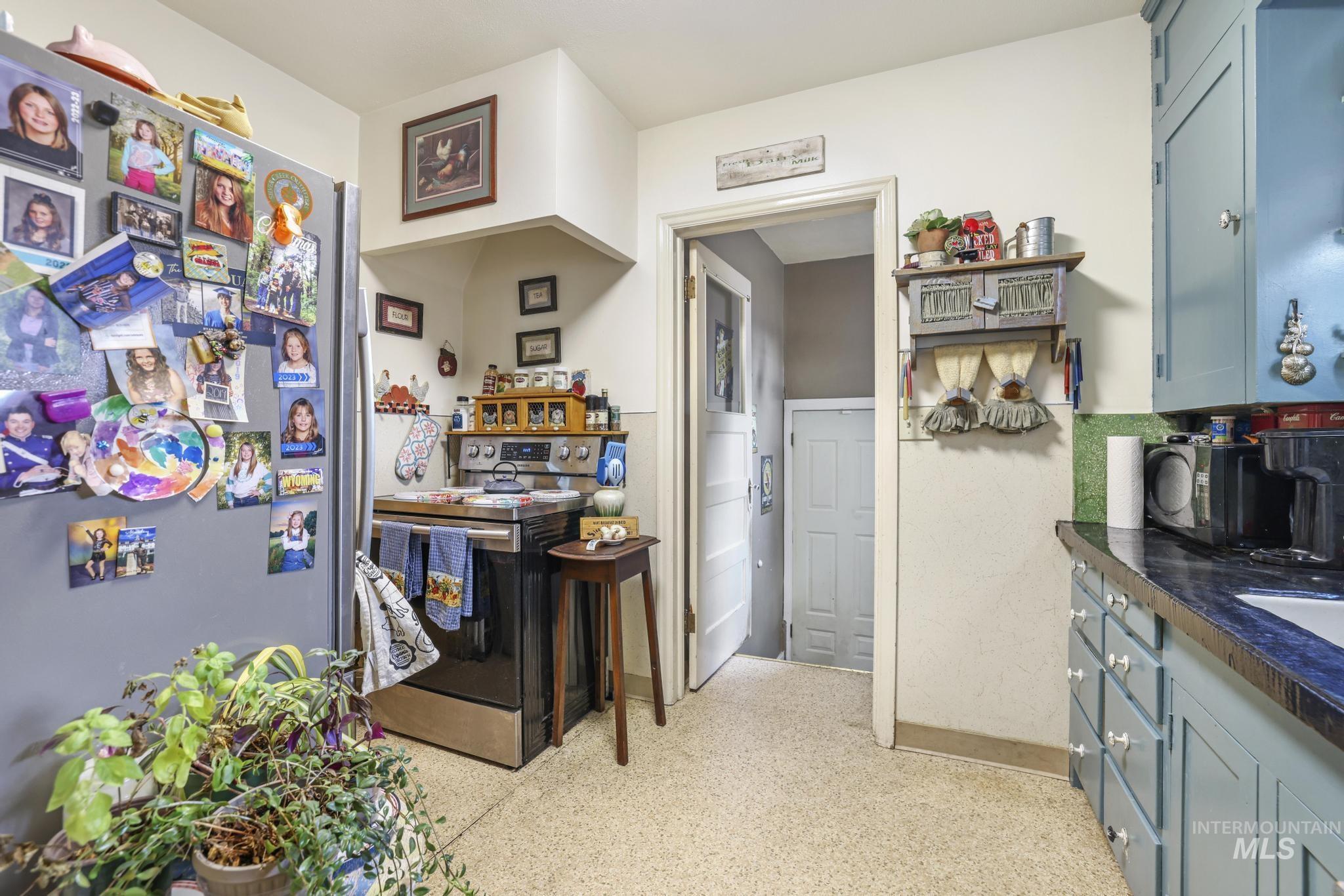 602 4th Avenue East Gooding, ID 83330 - Photo 8 of 36 Kitchen with stainless steel appliances and blue cabinetry
