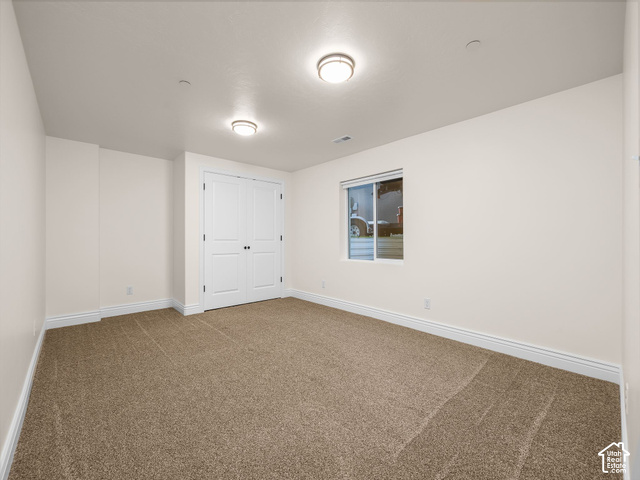 1288 North Horizon View Loop Elk Ridge, UT 84651 - Photo 24 of 38 Neutral tone wall paint, brown carpet flooring, flush mount ceiling lighting, and a white window frame with a sliding pane