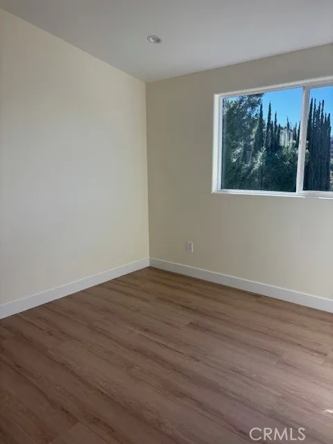 26173 Abdale Street Newhall, CA 91321 - Photo 12 of 15 a view of an empty room with wooden floor and a window