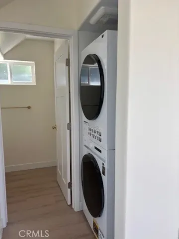 a view of a bedroom with washer and dryer