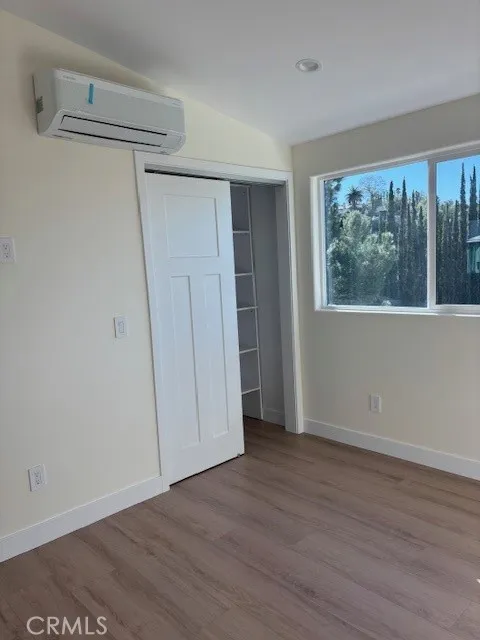 26173 Abdale Street Newhall, CA 91321 - Photo 6 of 15 a view of an empty room with wooden floor and a window