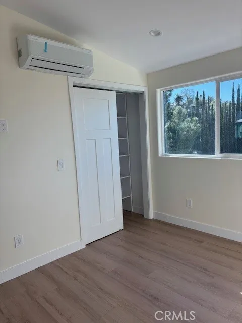 26173 Abdale Street Newhall, CA 91321 - Photo 6 of 15 a view of an empty room with wooden floor and a window