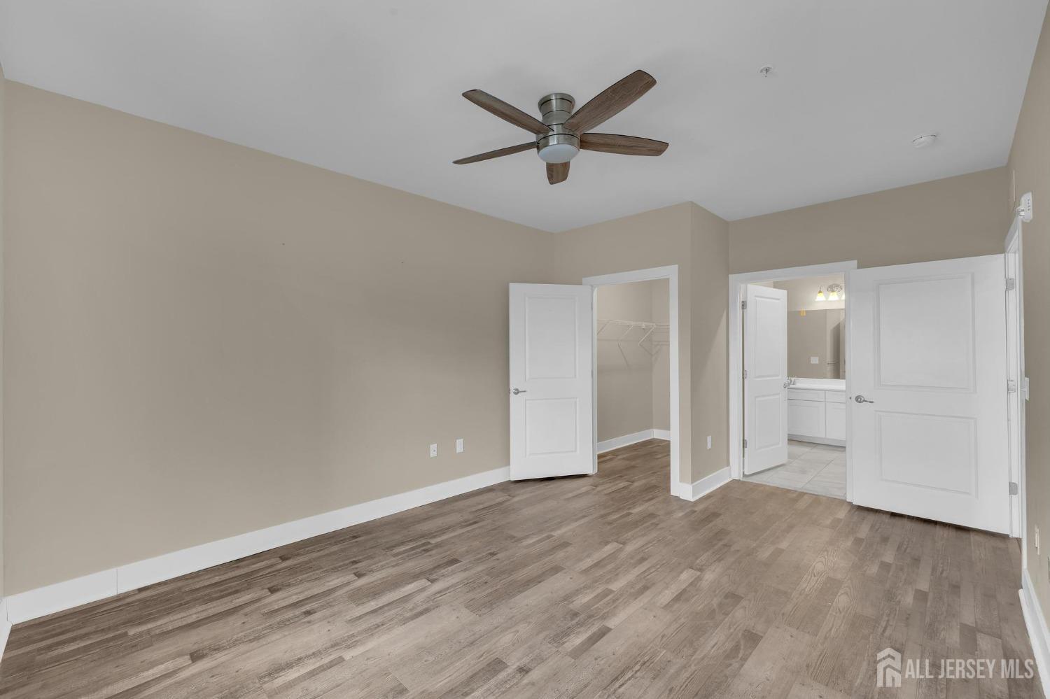 415 Tavern Road Monroe Township, NJ 08831 - Photo 14 of 39 an empty room with wooden floor and windows