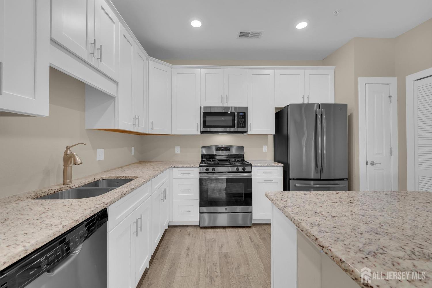 415 Tavern Road Monroe Township, NJ 08831 - Photo 15 of 39 a kitchen with stainless steel appliances granite countertop a sink stove and refrigerator