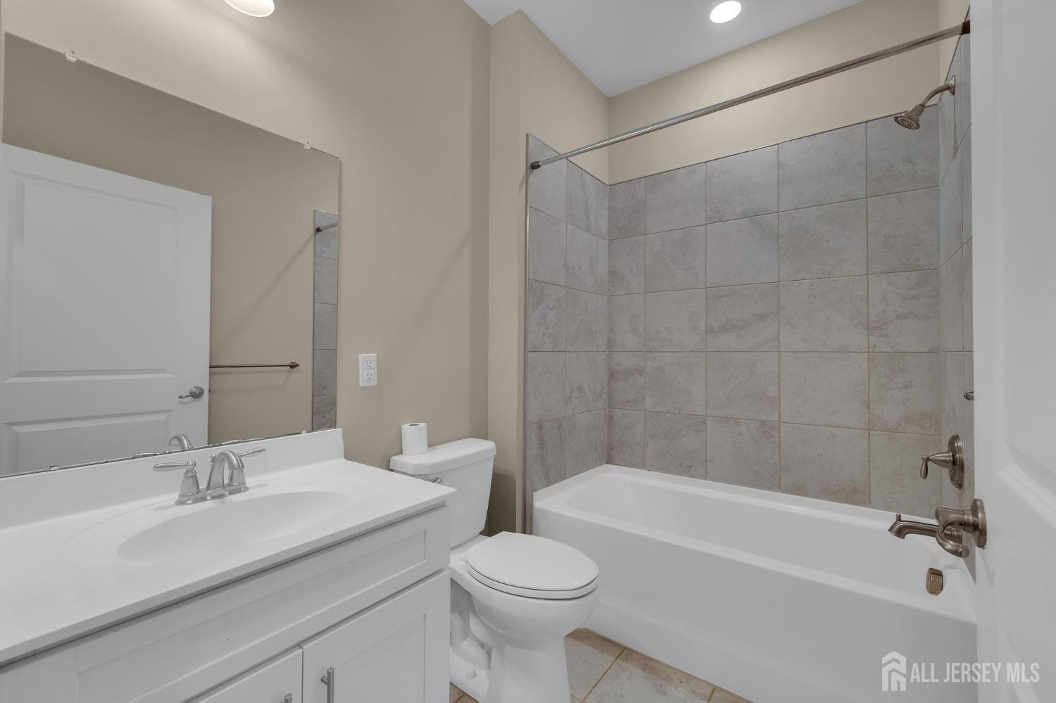 415 Tavern Road Monroe Township, NJ 08831 - Photo 18 of 39 a bathroom with a sink a toilet and a bathtub