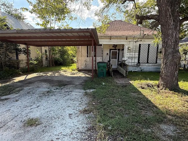 a view of a house with backyard porch and sitting area