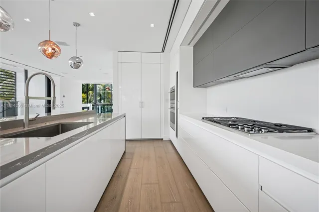 a kitchen with stainless steel appliances granite countertop a stove a sink and a refrigerator