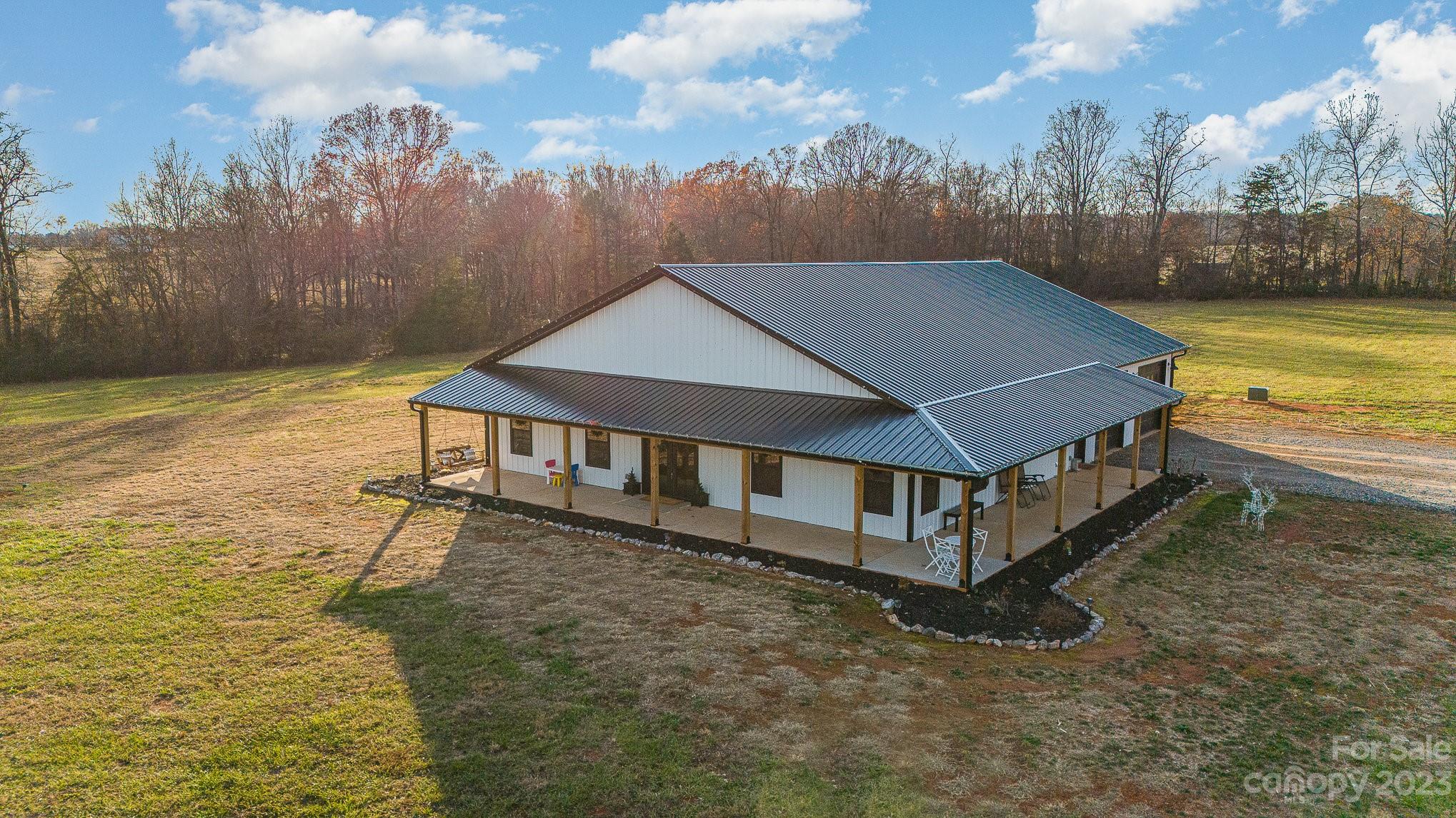 5261 Henderson Road Hamptonville, NC 27020 - Photo 1 of 46 a roof deck with table and chairs under an umbrella