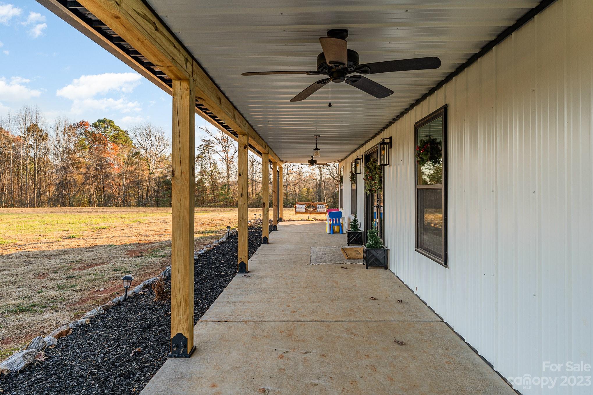 5261 Henderson Road Hamptonville, NC 27020 - Photo 12 of 46 a view of a porch with a floor to ceiling window and an entrance