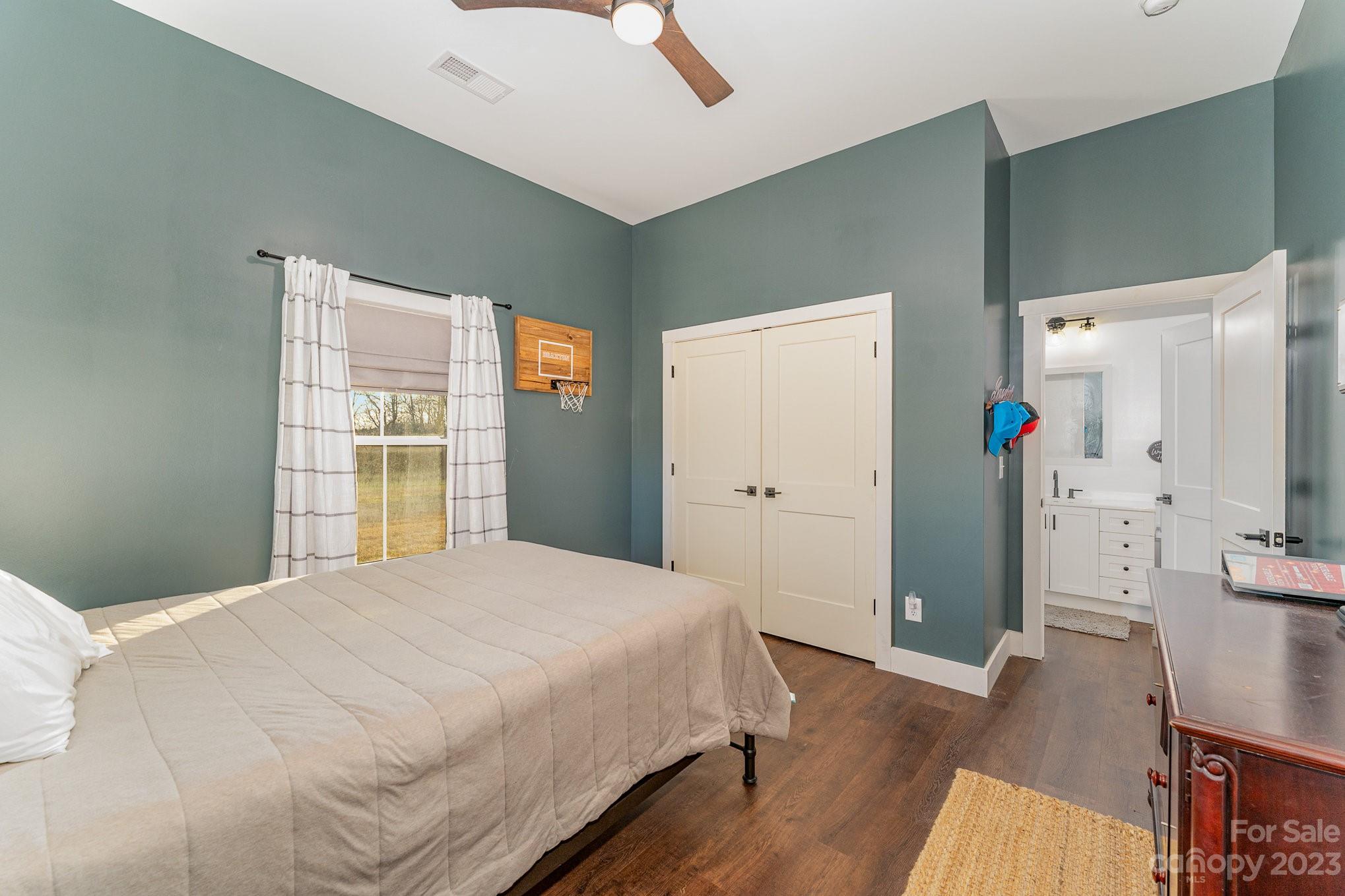 5261 Henderson Road Hamptonville, NC 27020 - Photo 15 of 46 a bedroom with a bed closet and a window