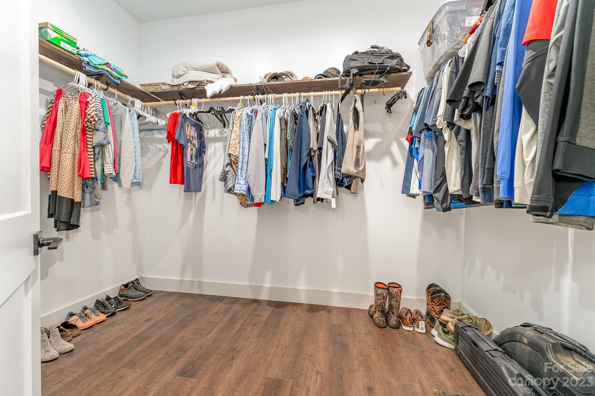 5261 Henderson Road Hamptonville, NC 27020 - Photo 25 of 46 a view of walk in closet with clothes and shoes
