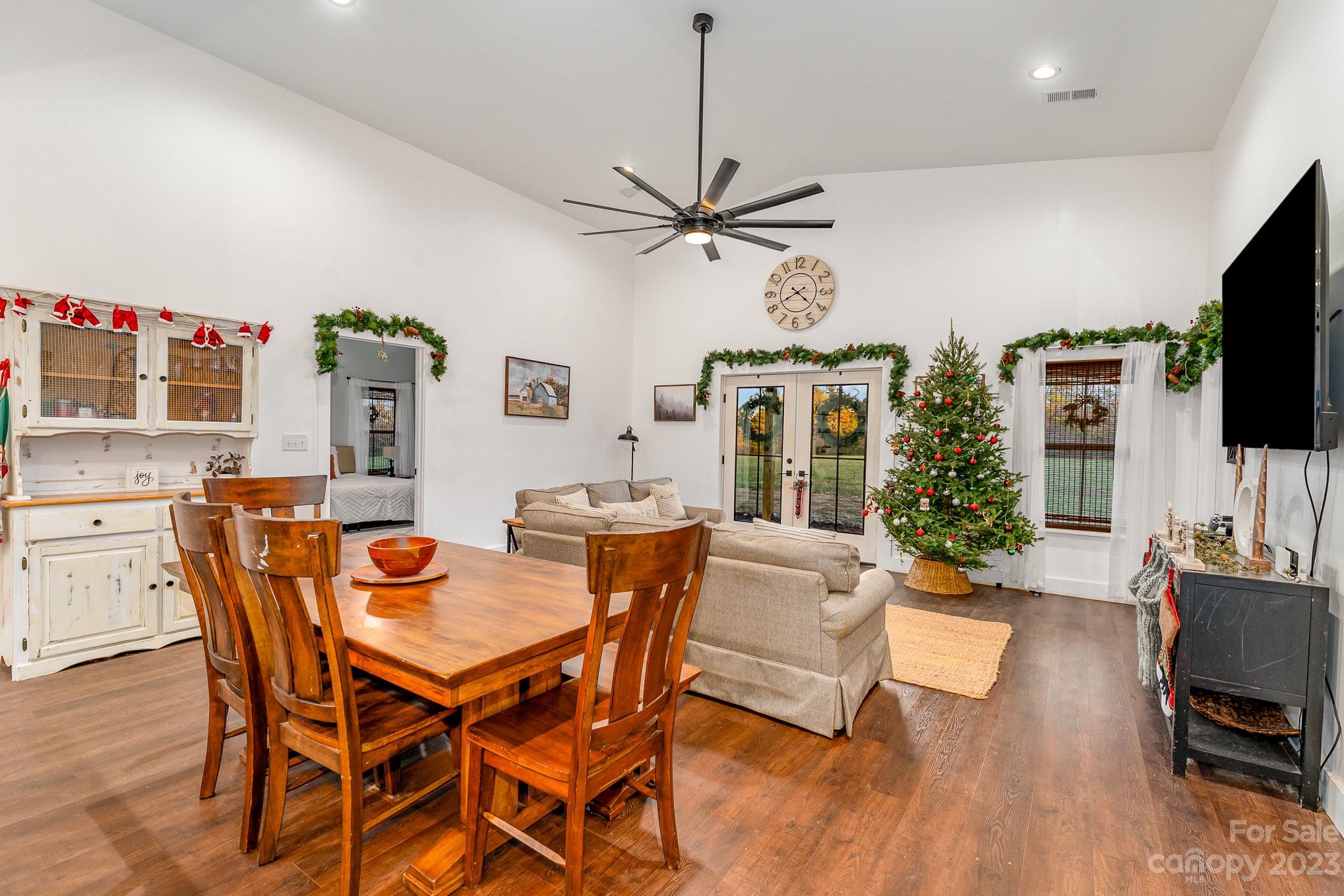 5261 Henderson Road Hamptonville, NC 27020 - Photo 28 of 46 a view of a dining room with furniture a chandelier and wooden floor