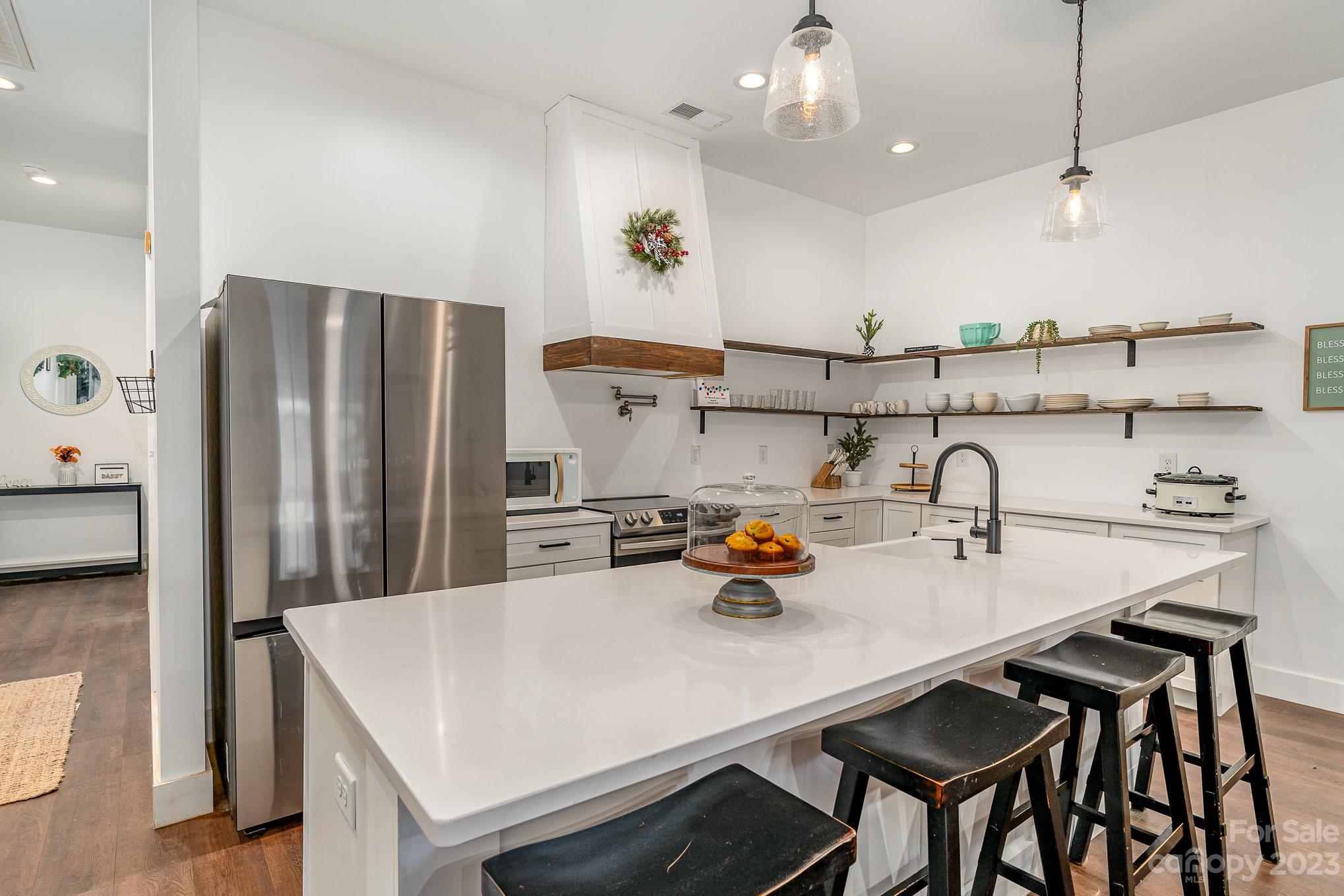 5261 Henderson Road Hamptonville, NC 27020 - Photo 3 of 46 a kitchen with stainless steel appliances a table chairs and a refrigerator