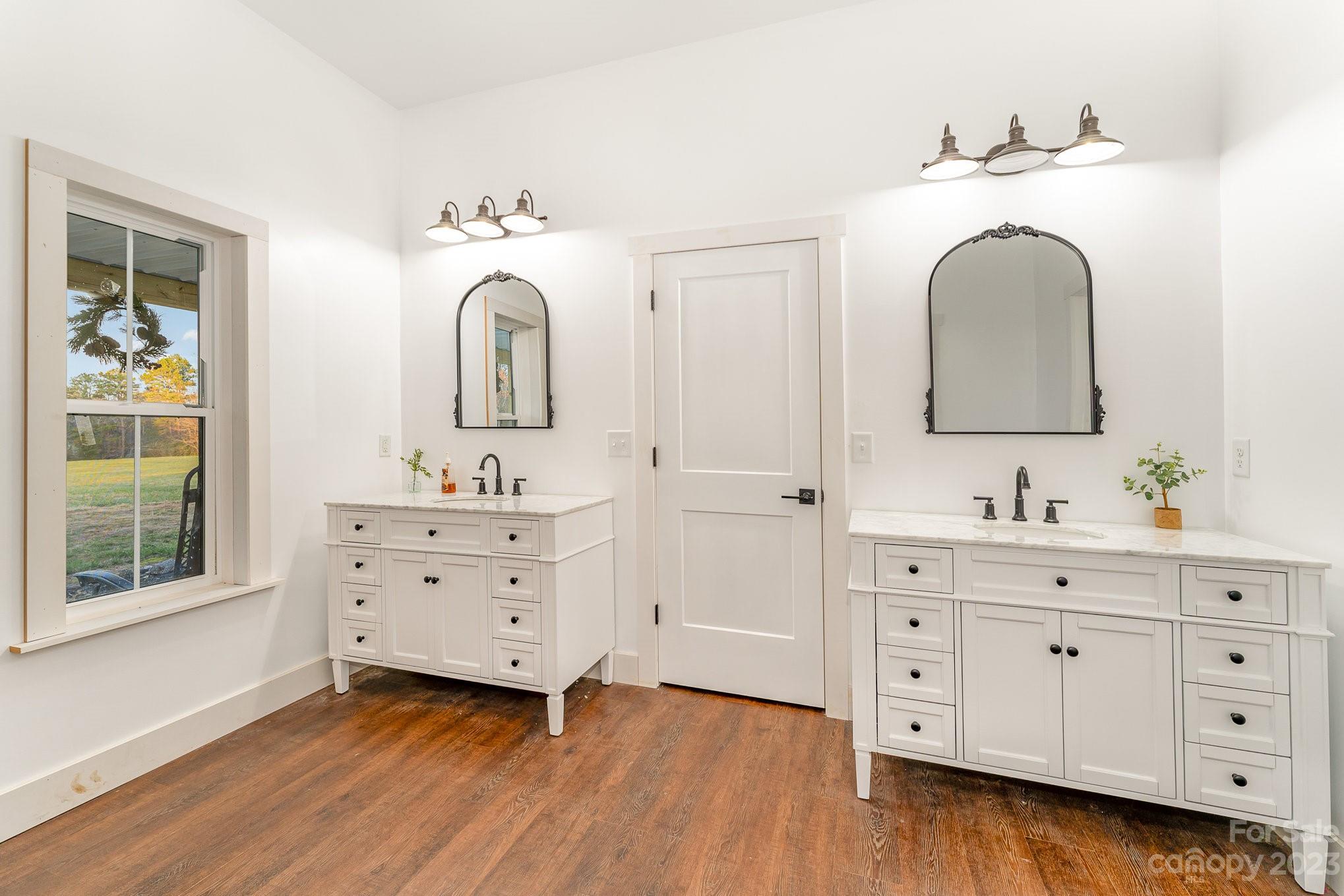 5261 Henderson Road Hamptonville, NC 27020 - Photo 4 of 46 a bathroom with a sink vanity and mirror