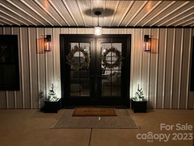 5261 Henderson Road Hamptonville, NC 27020 - Photo 46 of 46 a view of a hallway with wooden walls and stairs