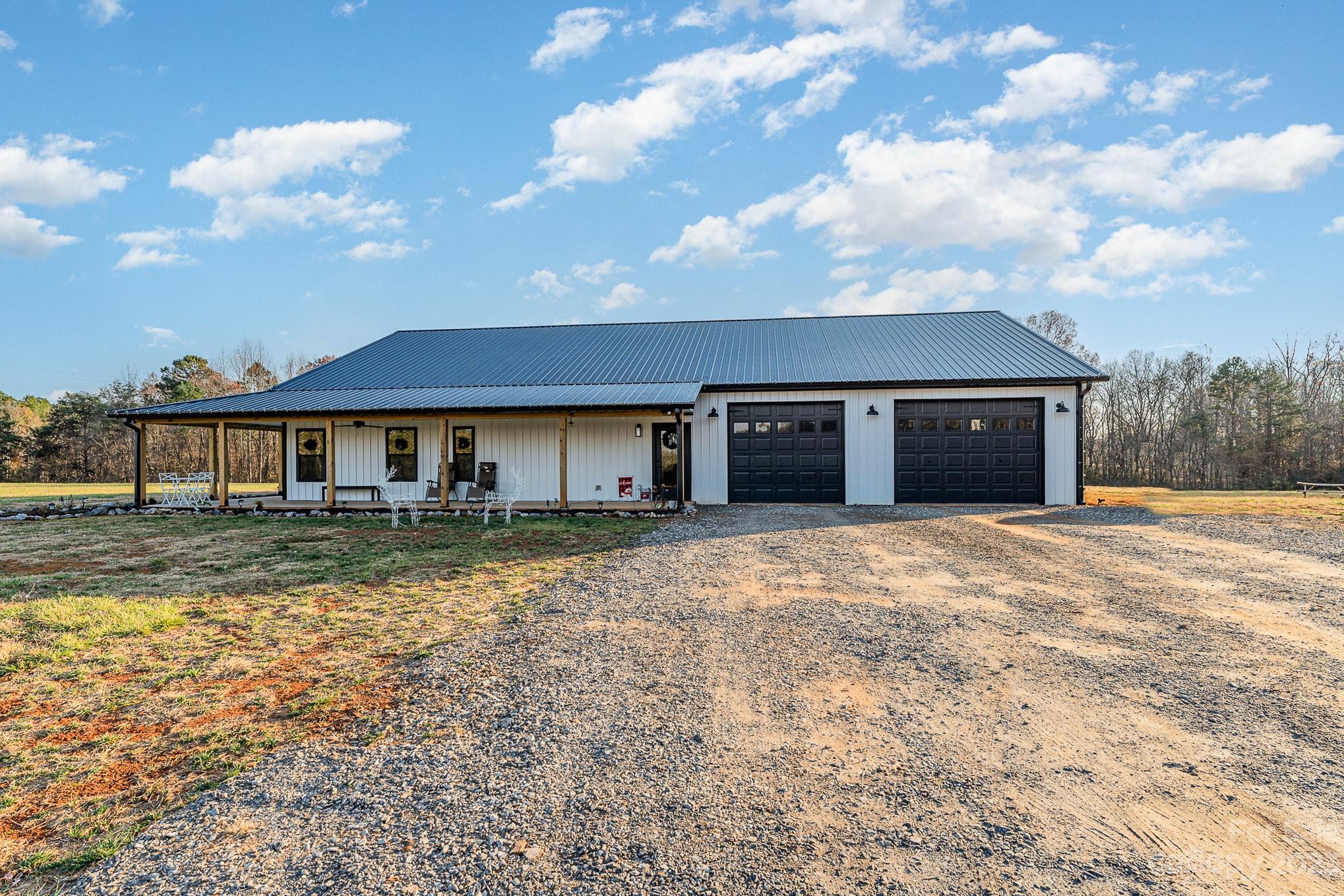 5261 Henderson Road Hamptonville, NC 27020 - Photo 9 of 46 a front view of a house with a yard and garage