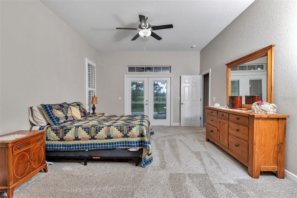 1989 Northwest 111th Loop Ocala, FL 34475 - Photo 21 of 55 a bed room with furniture and a chandelier