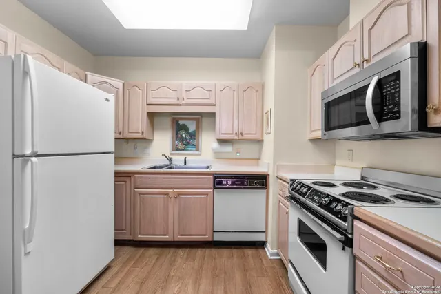 a kitchen with stainless steel appliances granite countertop a stove a microwave and a refrigerator