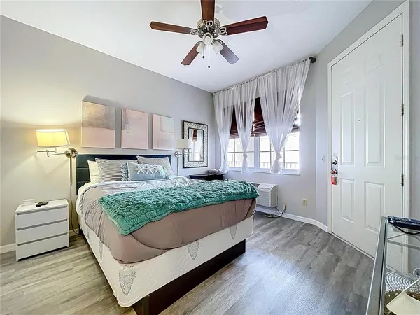 a bedroom with a bed and a flat screen tv