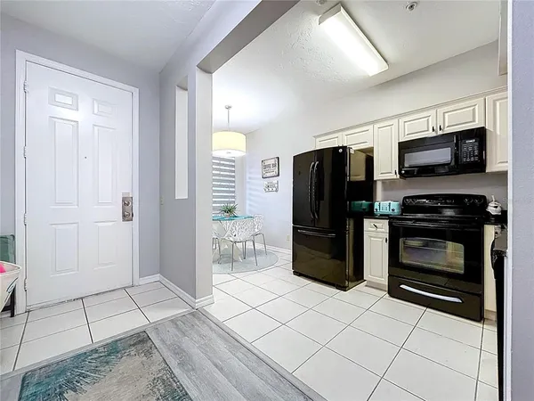 a kitchen with stainless steel appliances granite countertop a refrigerator a stove and a sink