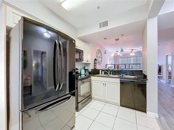 a kitchen with stainless steel appliances a refrigerator stove and microwave