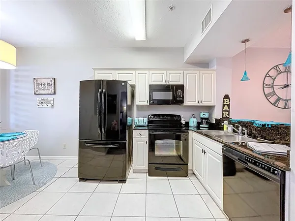 a kitchen with a sink stove and microwave