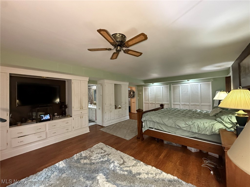 8116 Deer Road Southwest Bowerston, OH 44695 - Photo 23 of 49 Bedroom with multiple closets, dark wood-style floors, and a ceiling fan