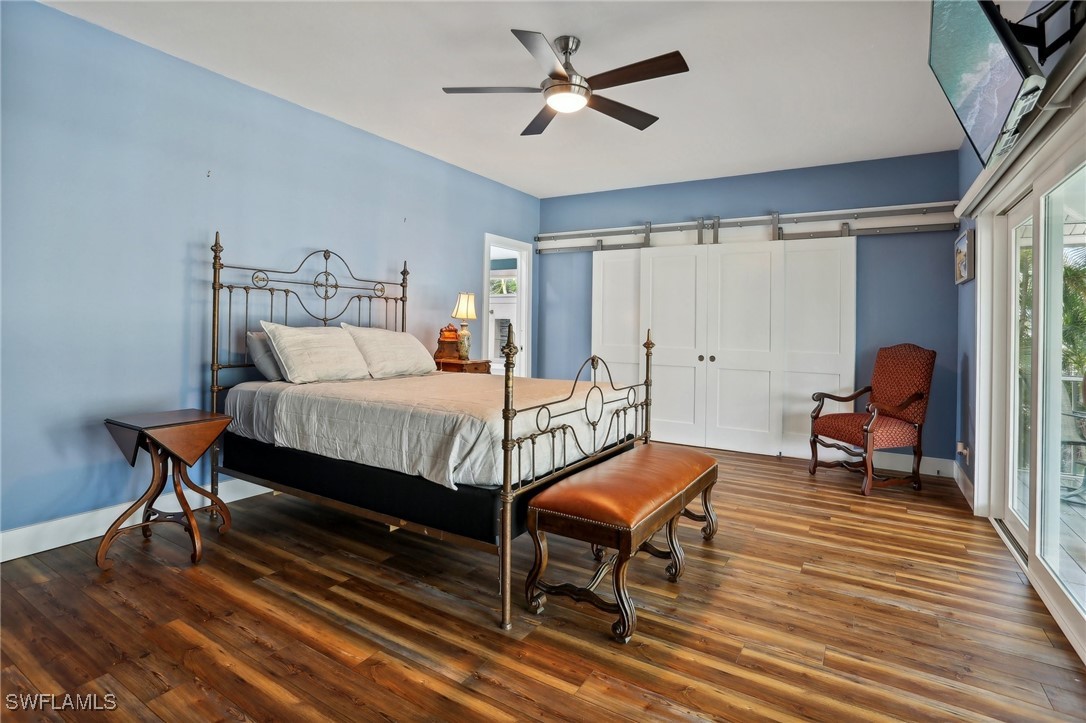 8335 Main Street Bokeelia, FL 33922 - Photo 29 of 47 a bedroom with furniture and a rug