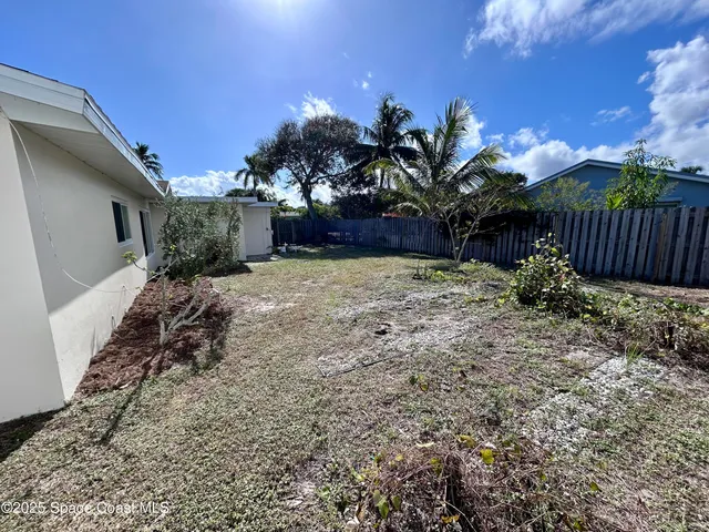 a view of a backyard of the house