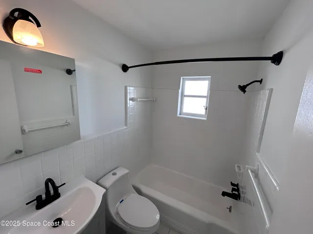 a bathroom with a toilet sink and bathtub