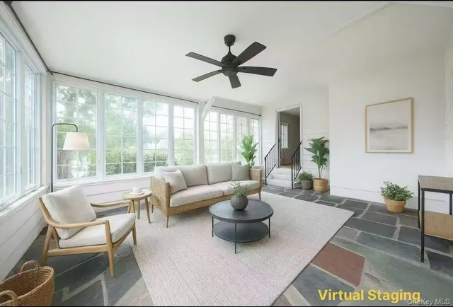 a living room with furniture and a large window