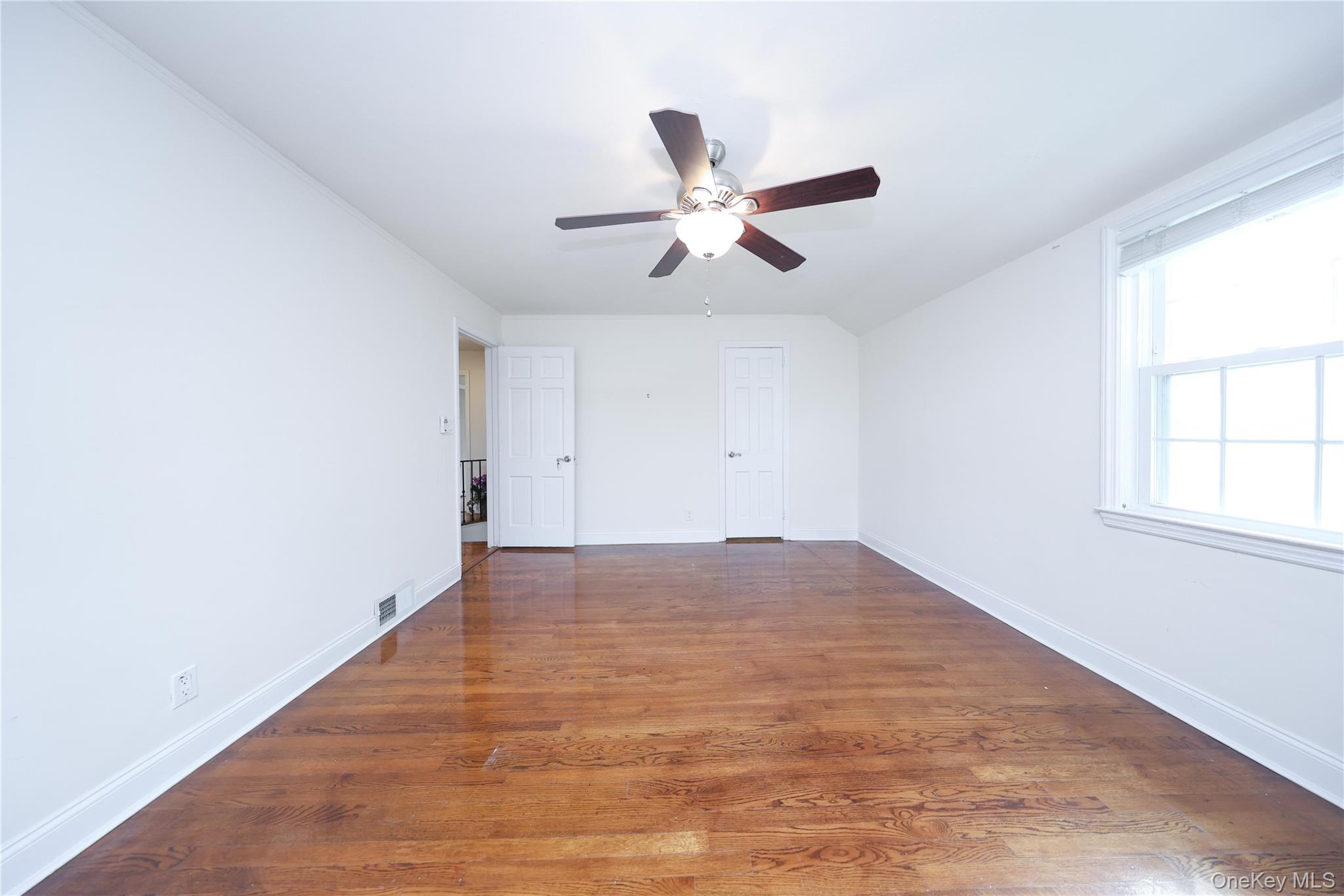 17 Pinewood Road Manhasset, NY 11030 - Photo 13 of 26 wooden floor in an empty room with a window