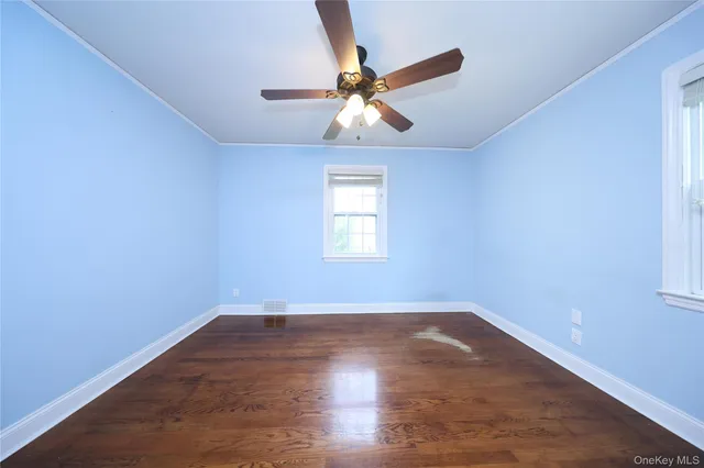 wooden floor in an empty room with a window