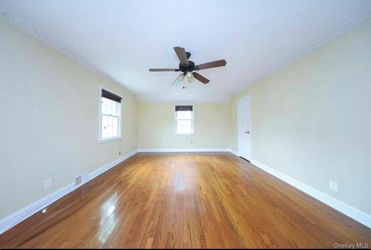 17 Pinewood Road Manhasset, NY 11030 - Photo 18 of 26 an empty room with wooden floor and windows