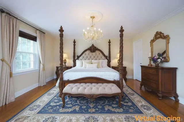 a view of a bedroom with bed and wooden floor