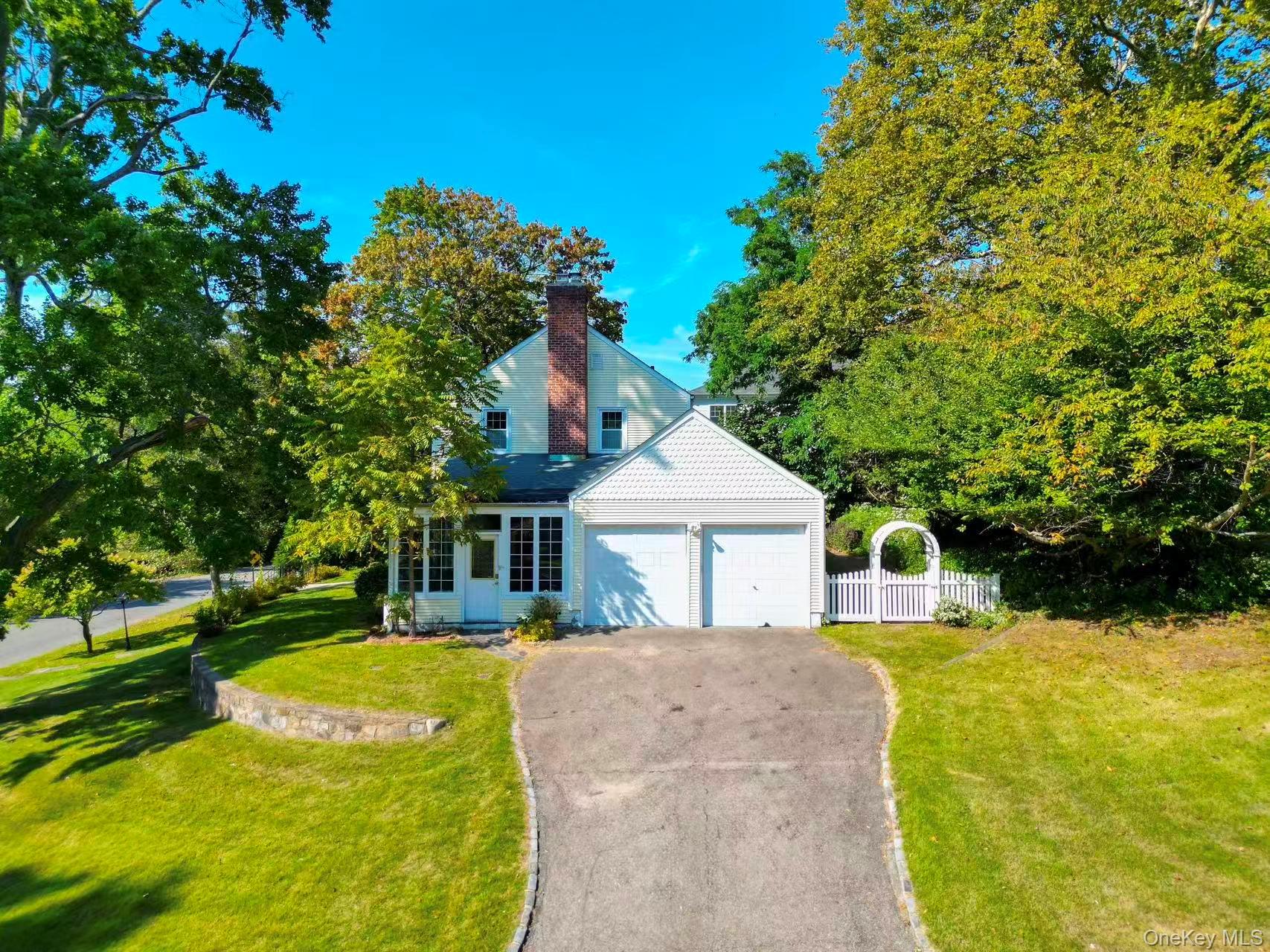 17 Pinewood Road Manhasset, NY 11030 - Photo 2 of 26 a front view of a house with a yard