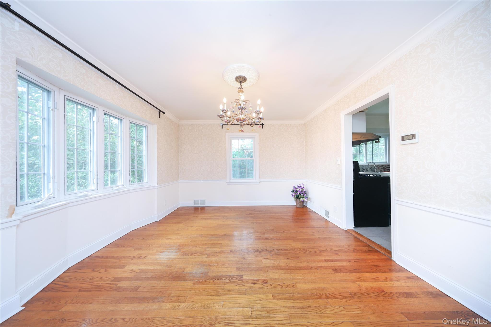 17 Pinewood Road Manhasset, NY 11030 - Photo 4 of 26 wooden floor in an empty room with a window