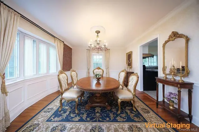 a dining room with furniture a rug and a chandelier