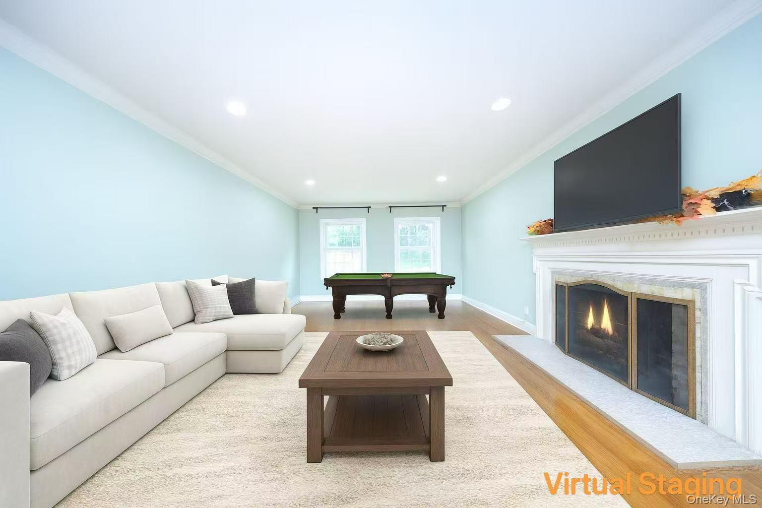 17 Pinewood Road Manhasset, NY 11030 - Photo 10 of 26 a living room with furniture a fireplace and a flat screen tv