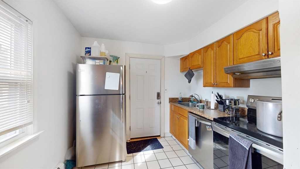479 High Street Dedham, MA 02026 - Photo 11 of 22 a kitchen with stainless steel appliances a refrigerator a sink a stove a washer dryer and a refrigerator
