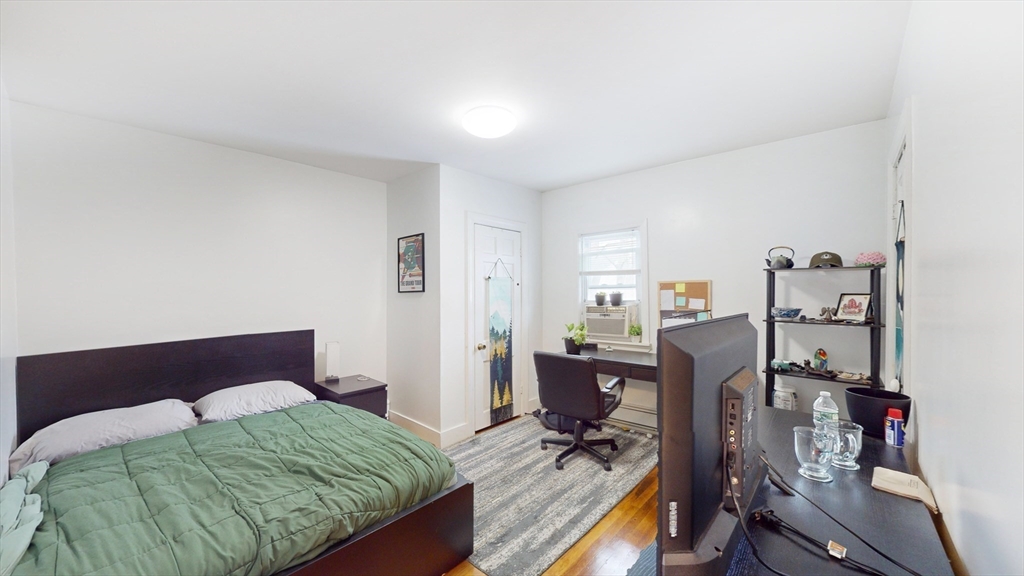 479 High Street Dedham, MA 02026 - Photo 12 of 22 a bedroom with a bed and wooden floor
