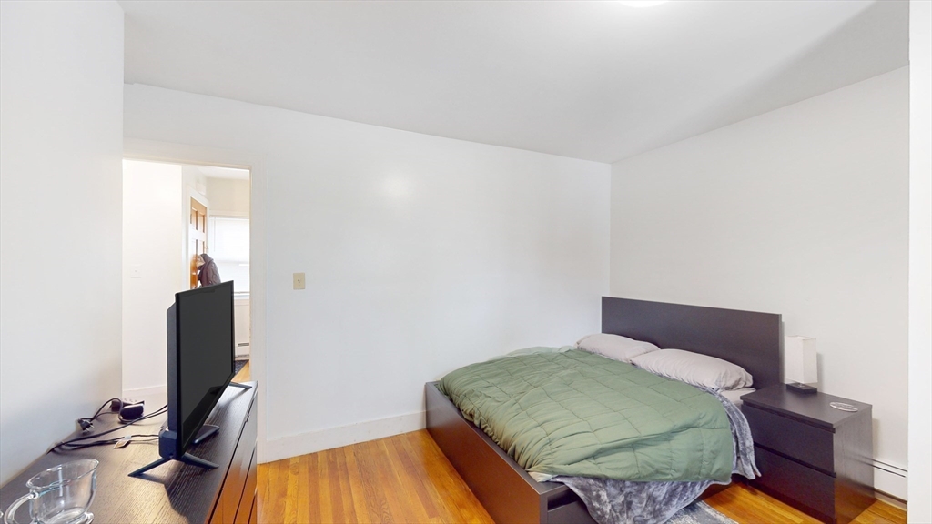 479 High Street Dedham, MA 02026 - Photo 13 of 22 a bedroom with a bed and wooden floor