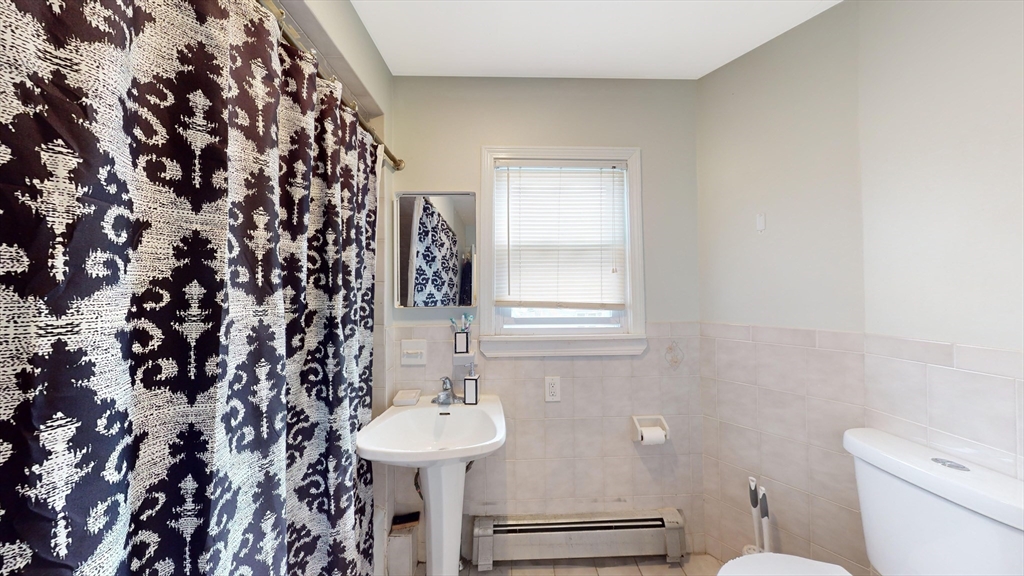 479 High Street Dedham, MA 02026 - Photo 14 of 22 a bathroom with a sink toilet and mirror