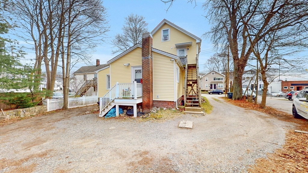 479 High Street Dedham, MA 02026 - Photo 19 of 22 a view of a house with a patio table and chairs