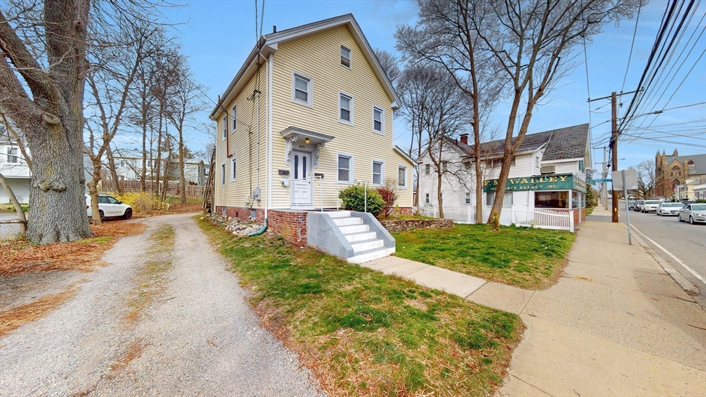 479 High Street Dedham, MA 02026 - Photo 22 of 22 a view of a white house next to a road and yard