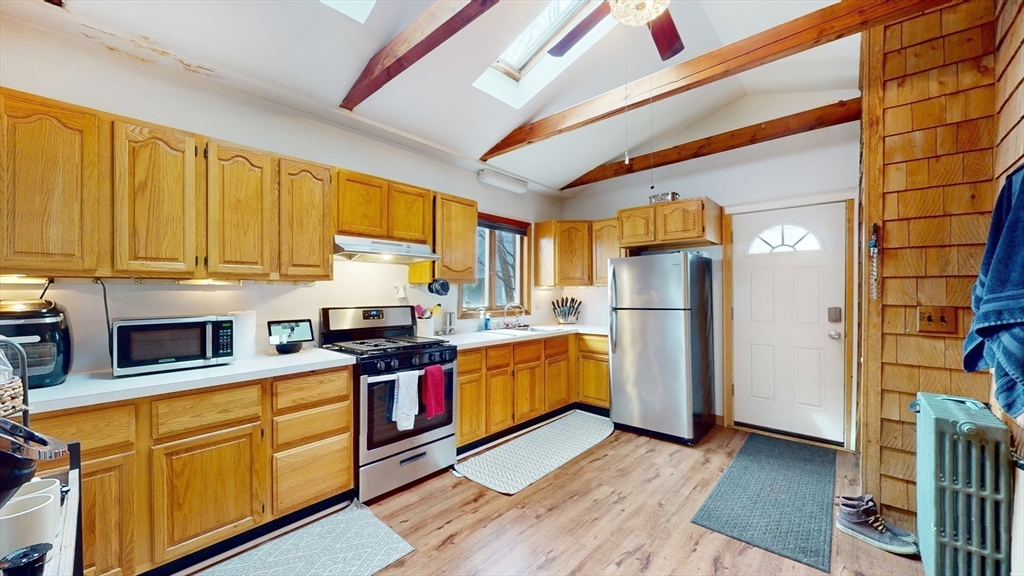 479 High Street Dedham, MA 02026 - Photo 5 of 22 a kitchen with stainless steel appliances granite countertop a refrigerator a stove and a sink