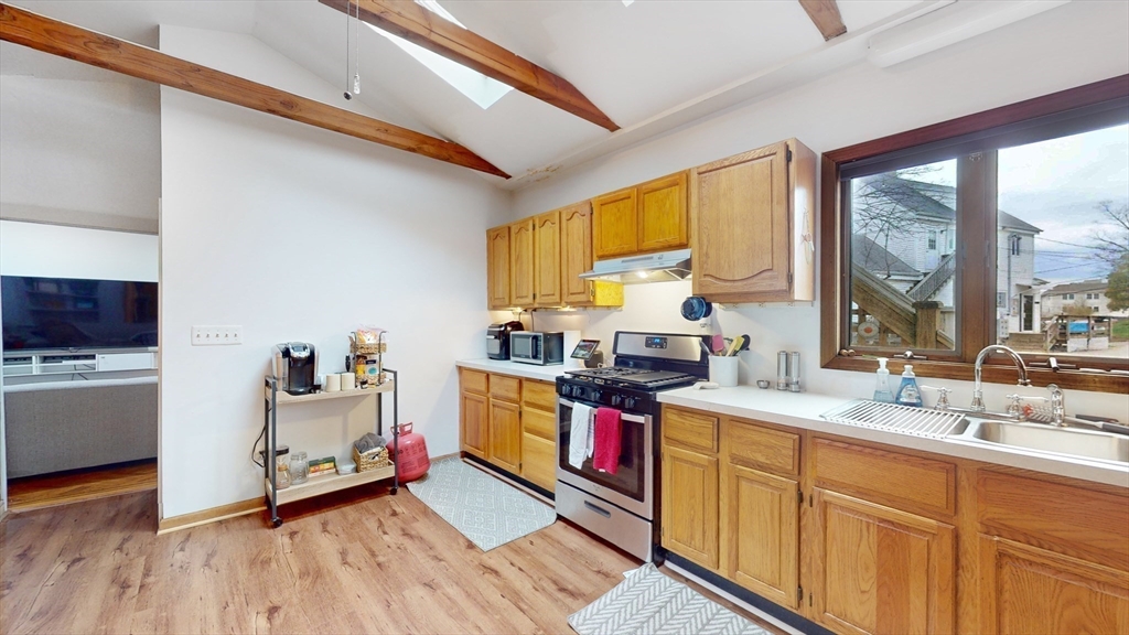 479 High Street Dedham, MA 02026 - Photo 6 of 22 a kitchen that has a sink and a wooden floor