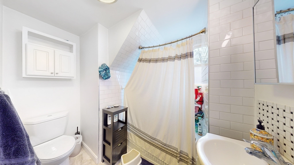 479 High Street Dedham, MA 02026 - Photo 8 of 22 a bathroom with a sink toilet and shower